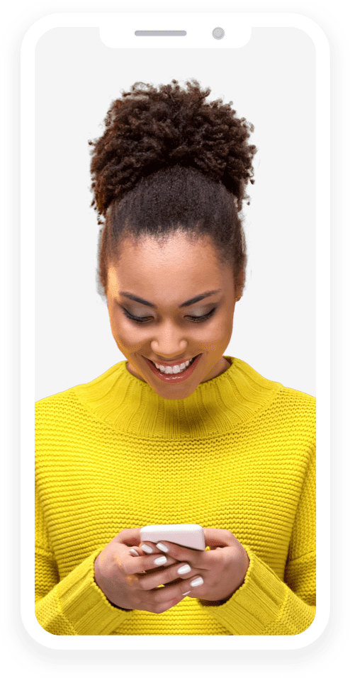 woman in yellow sweater smiles down at her smart phone
